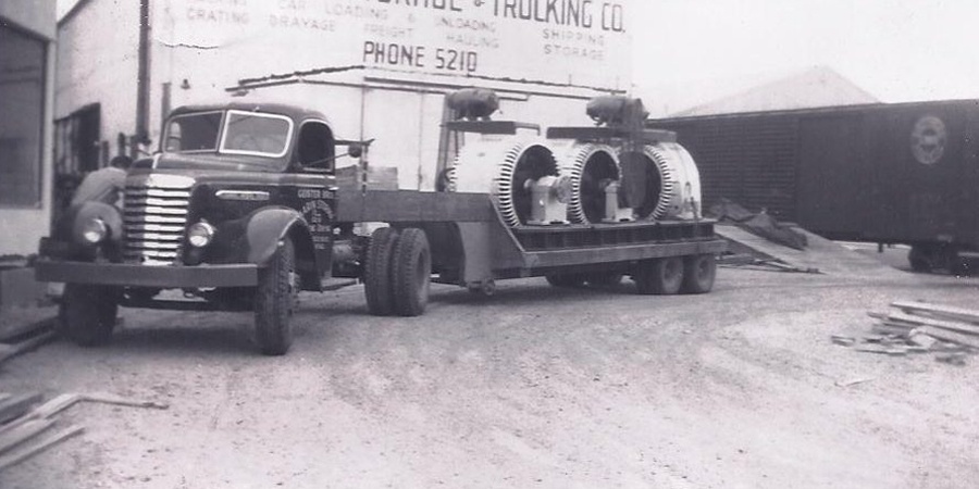 1940s B&W photo of transport truck trailer loaded with electrical equipment